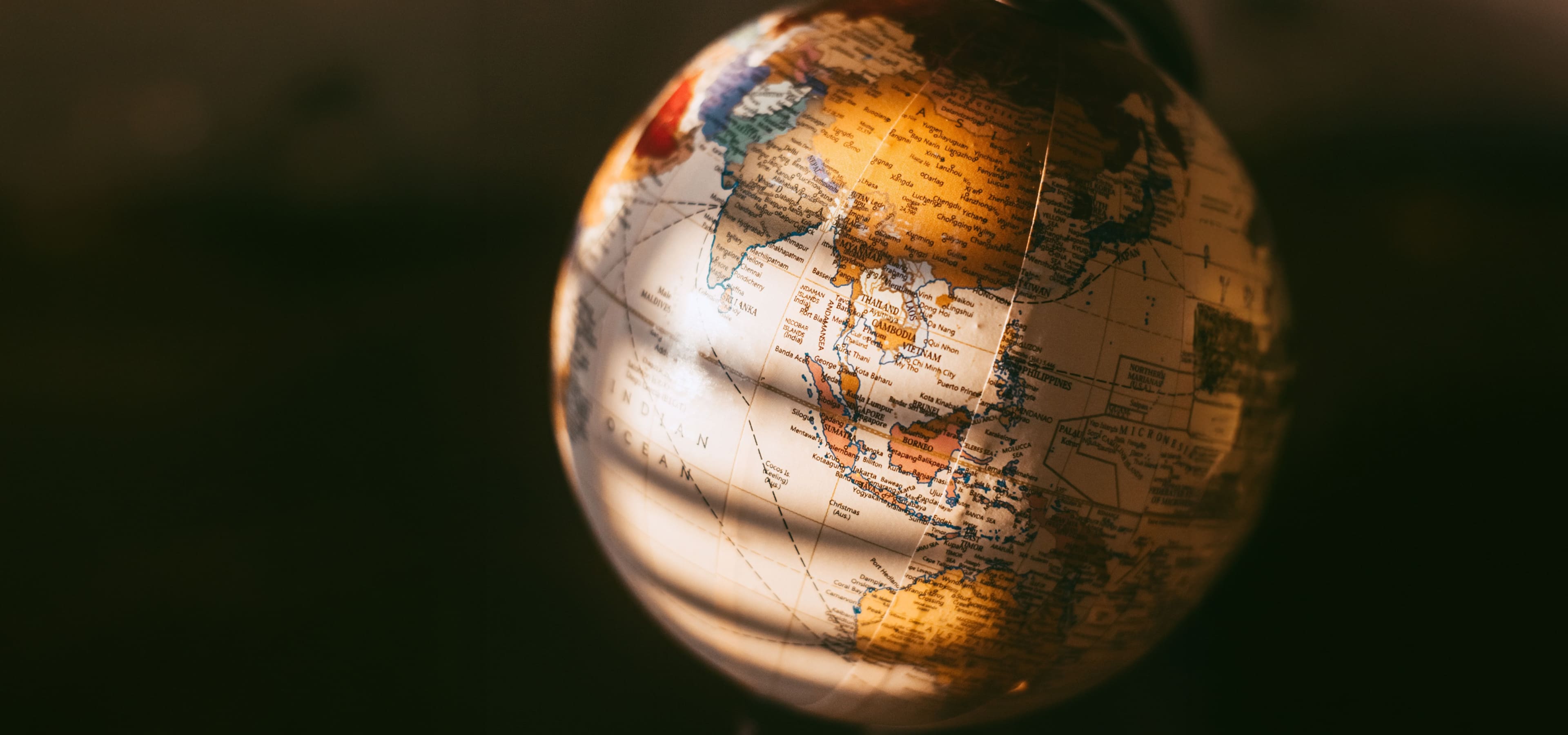 Cinematic lit globe focusing on Asia with text highlighting the 'Send' feature, promoting instant, low-fee global remittances and money transfers to family in the Philippines via Coins.ph, bank accounts, and e-wallets